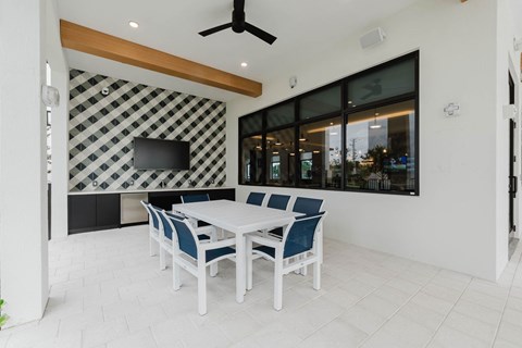 A dining room with a checkered wallpaper and a black and white color scheme.