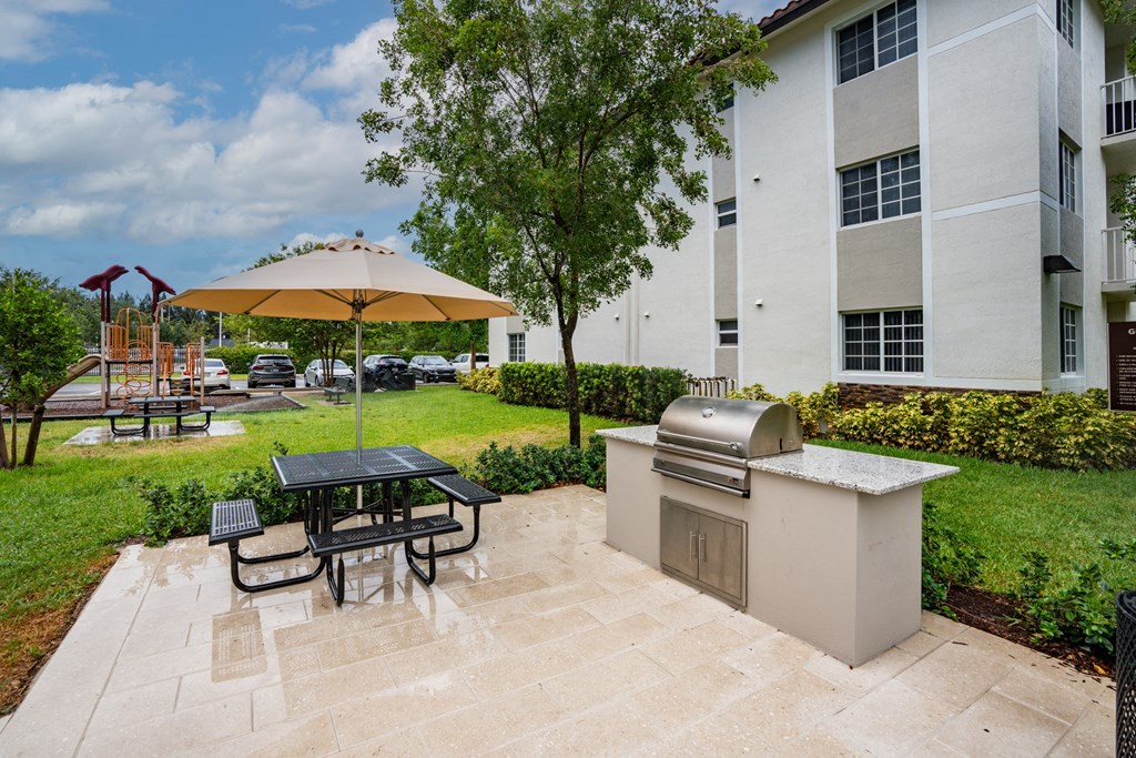 our apartments have a patio with a grill and a picnic table