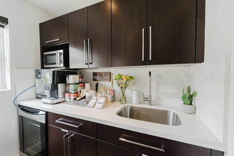 A kitchen with brown cabinets and a white countertop.