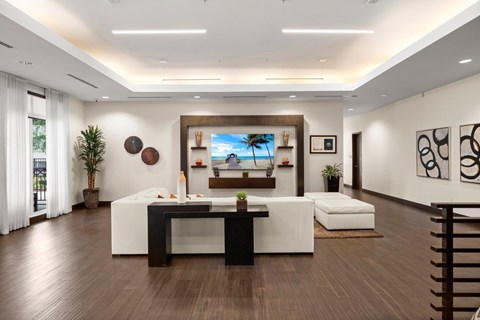 A modern living room with a white sofa and a television.