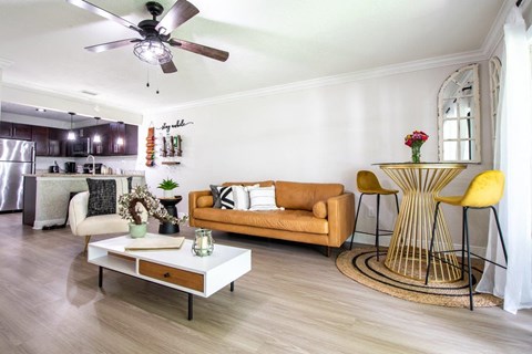 a living room with a couch and a ceiling fan
