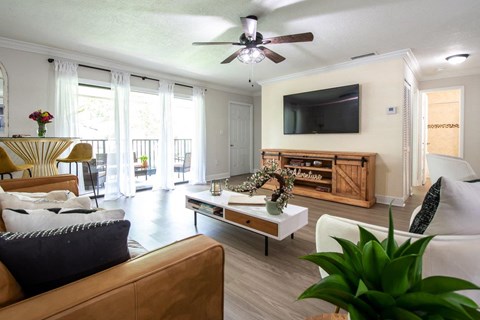 a living room with a couch and a ceiling fan