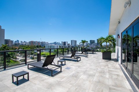 a balcony with chairs and a view of the city