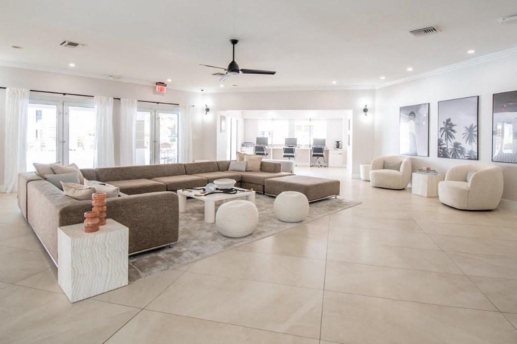 a living room filled with furniture and a ceiling fan