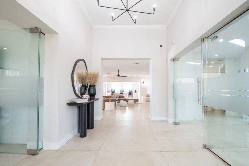 a hallway with glass doors and white walls