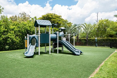 a playground with two slides and a swing set