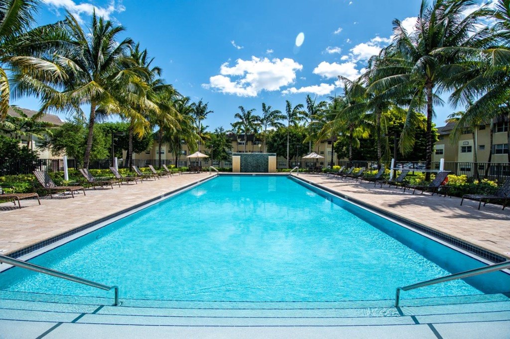 a swimming pool at a resort with palm trees