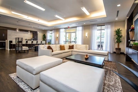 a large living room with white couches and a coffee table