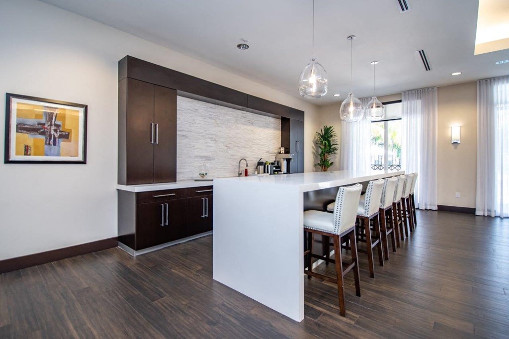 a kitchen with a large island and a table with chairs