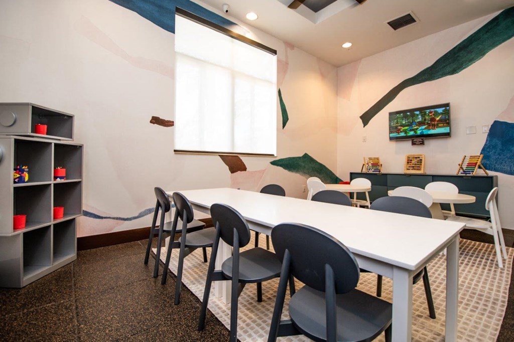 a conference room with a white table and chairs