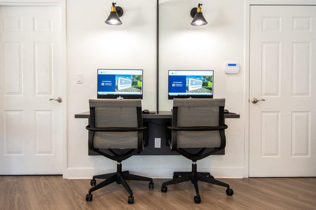 a room with two computer monitors on top of a table