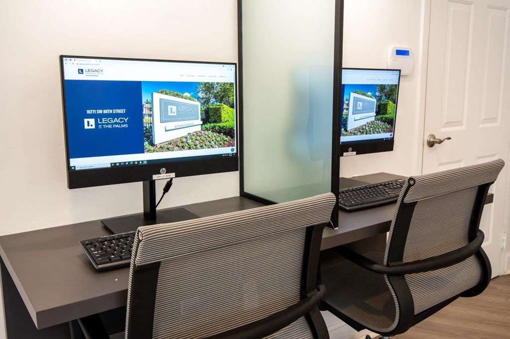 a desk with two monitors and a laptop computer on it