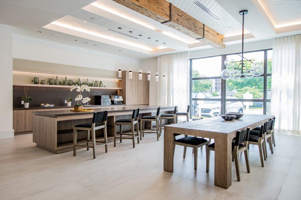 a large dining room and kitchen with a table and chairs
