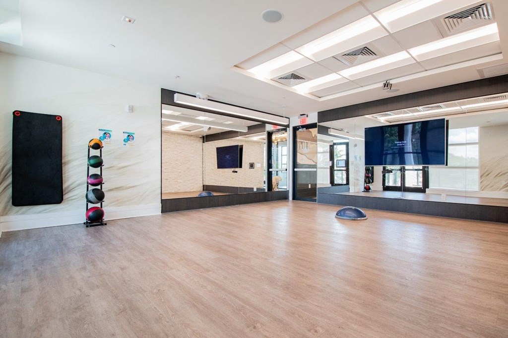 a large room with a hard wood floor and a yoga studio