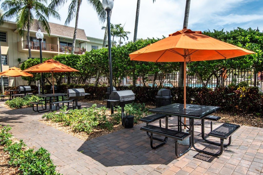 BBQ Area with picnic tables and umbrellas
