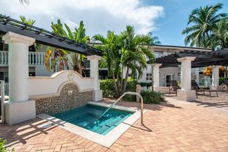 a small pool is in the middle of a house with palm trees