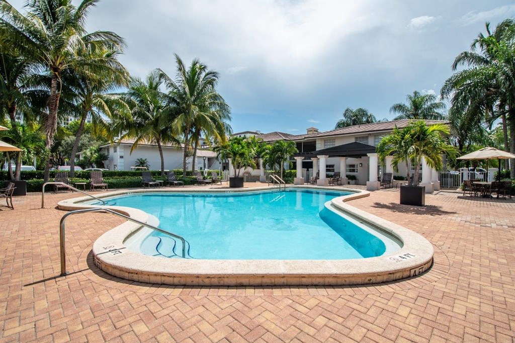a swimming pool at a resort with palm trees