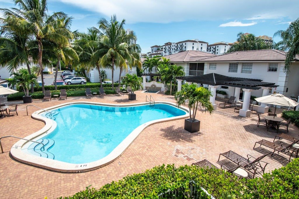 a swimming pool at a resort with palm trees