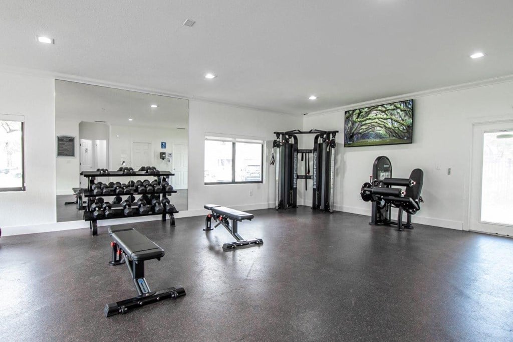 the generously sized fitness room is equipped with weights and cardio equipment