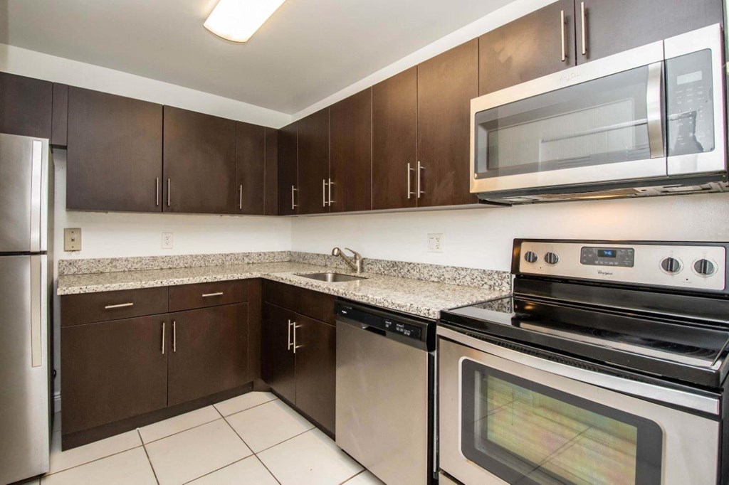 a kitchen with stainless steel appliances and granite counter tops
