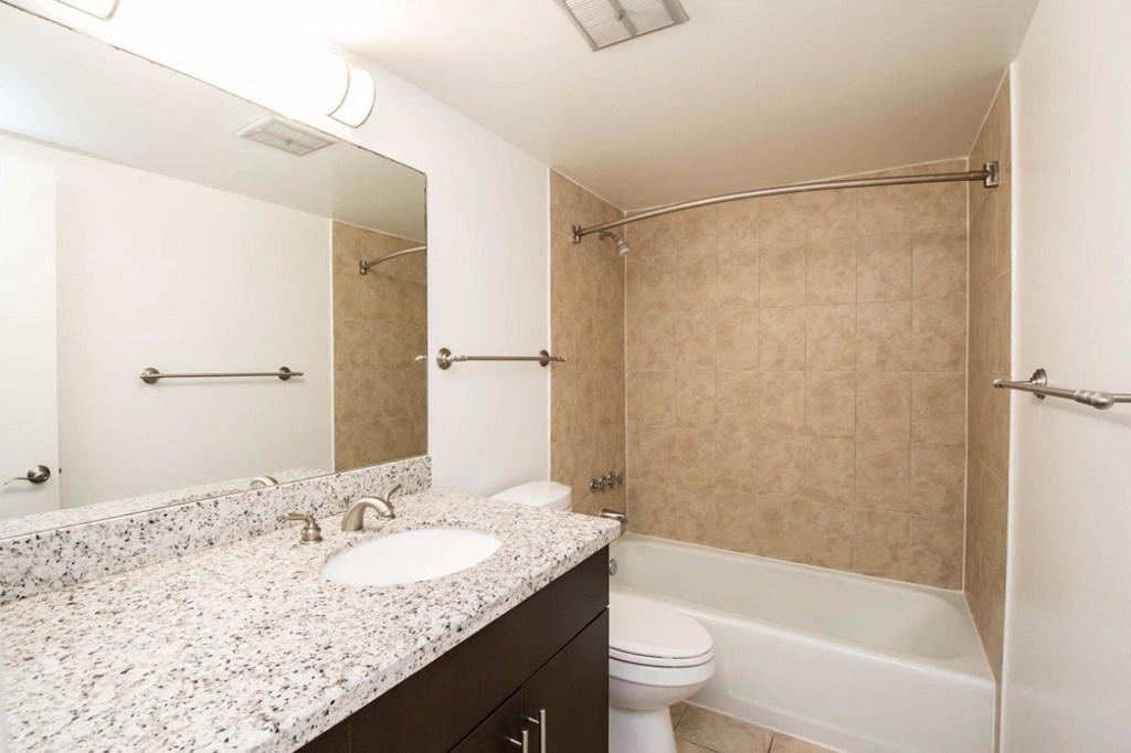 a bathroom with a sink and a shower and a toilet