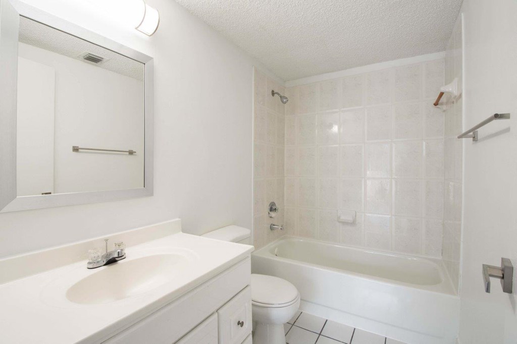 a bathroom with a sink toilet and a bath tub