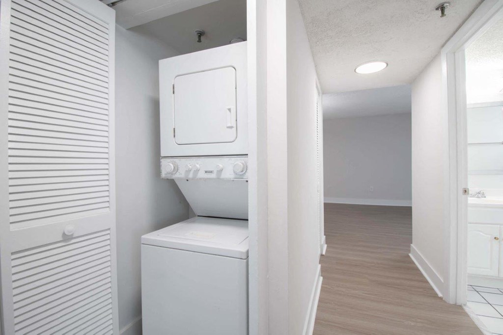 a white laundry room with a washer and dryer in it