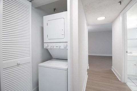 a white laundry room with a washer and dryer in it