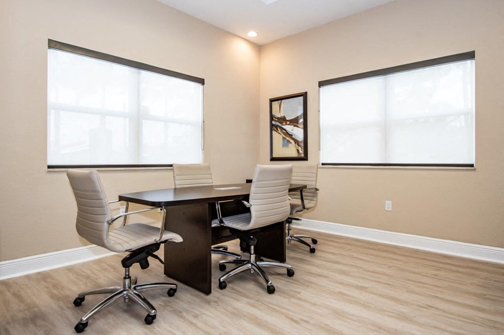 a conference room with a table and chairs