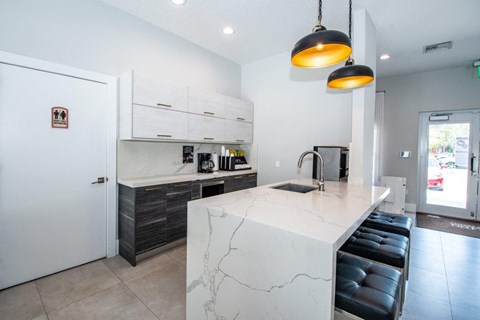 a kitchen with a marble counter top and a sink
