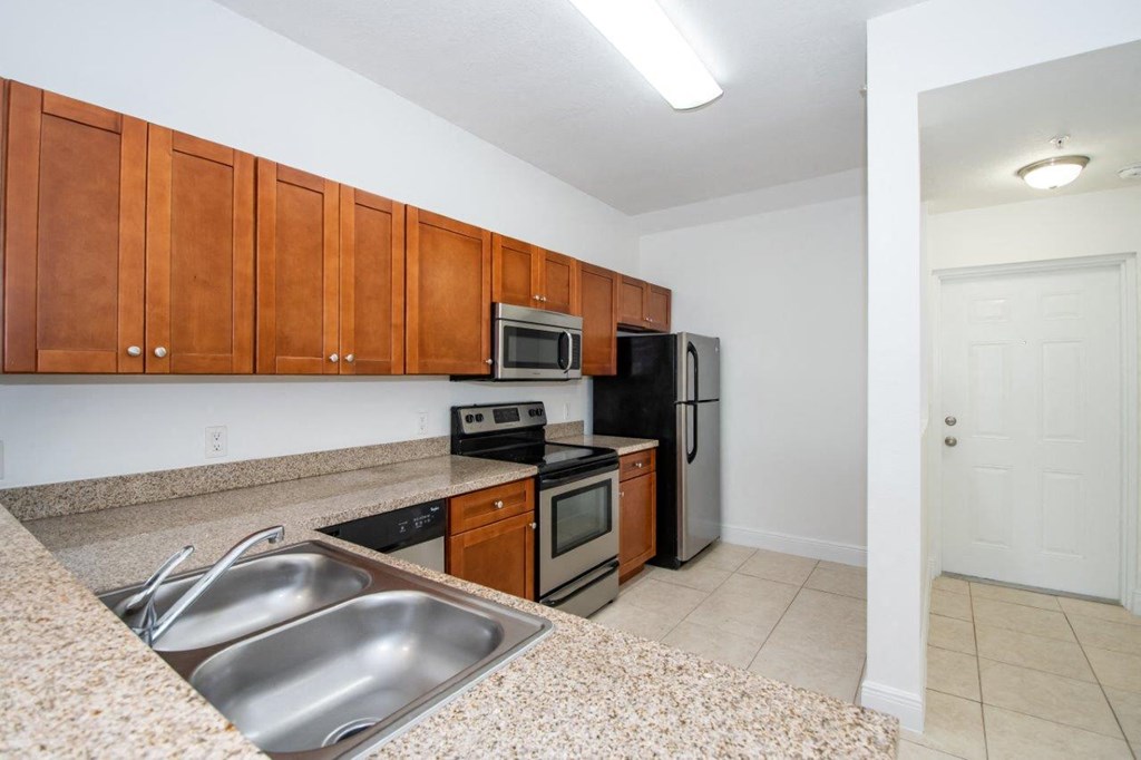 a kitchen with stainless steel appliances and granite counter tops