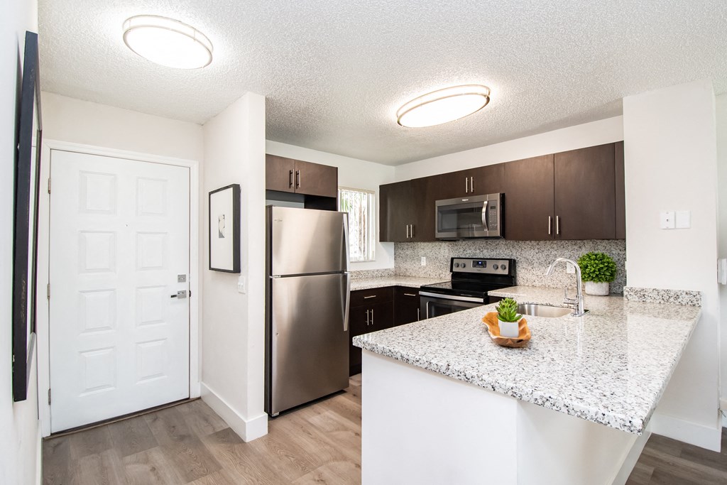 a kitchen with stainless steel appliances and a granite counter top
