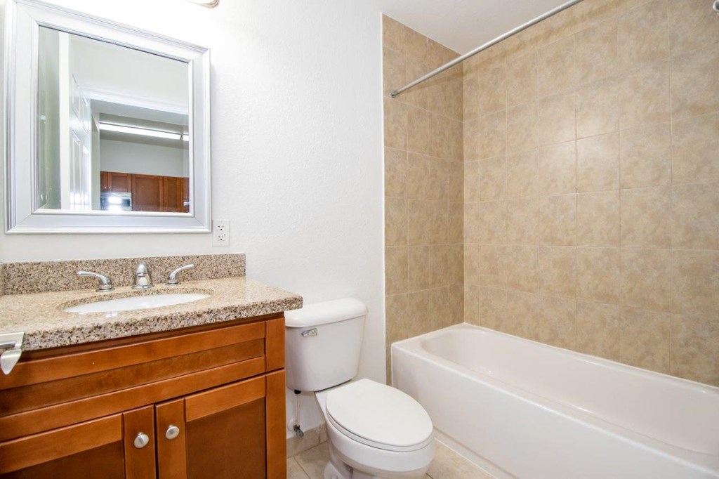 a bathroom with a sink toilet and a bath tub