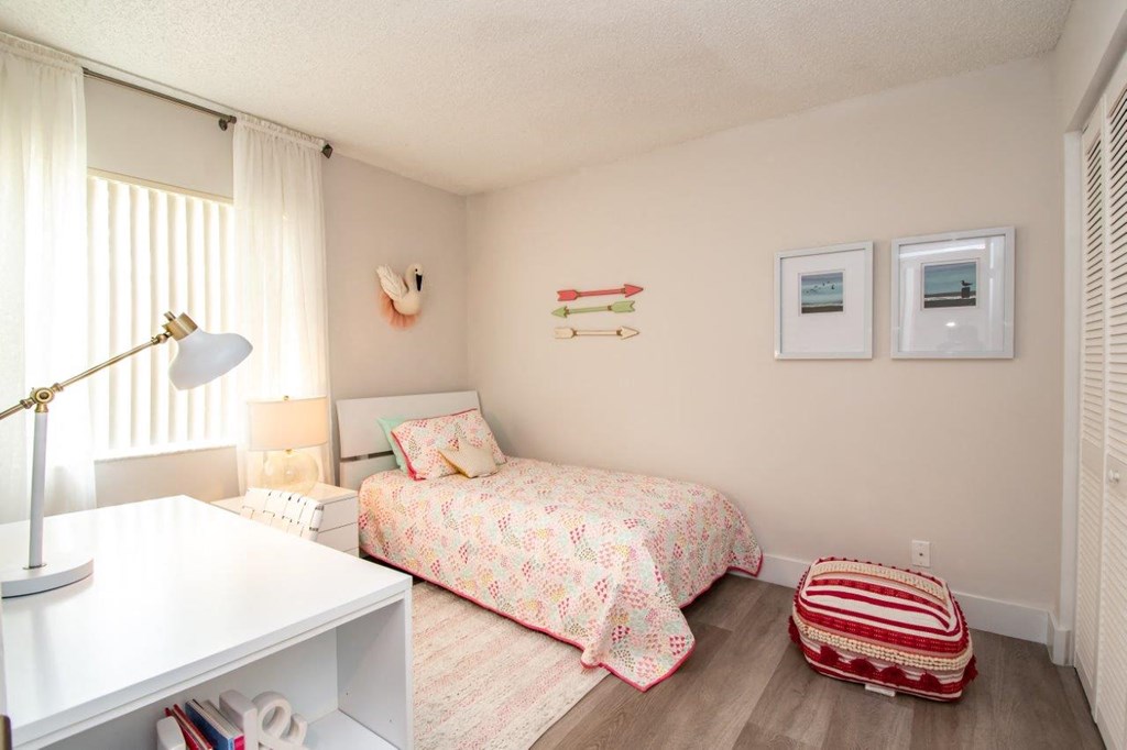 a bedroom with a bed and a desk