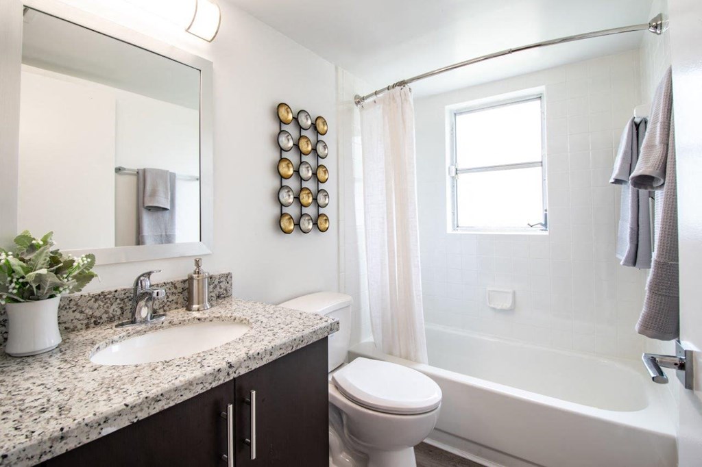 a bathroom with a sink toilet and a bath tub
