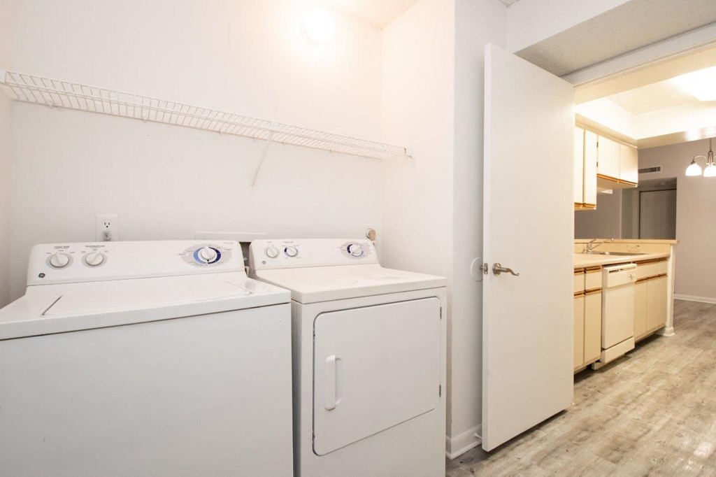 a washer and dryer in a room with a sink and a laundry room