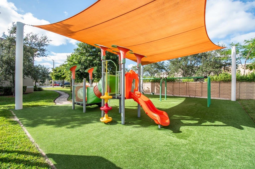 a playground with a swing set under a canopy