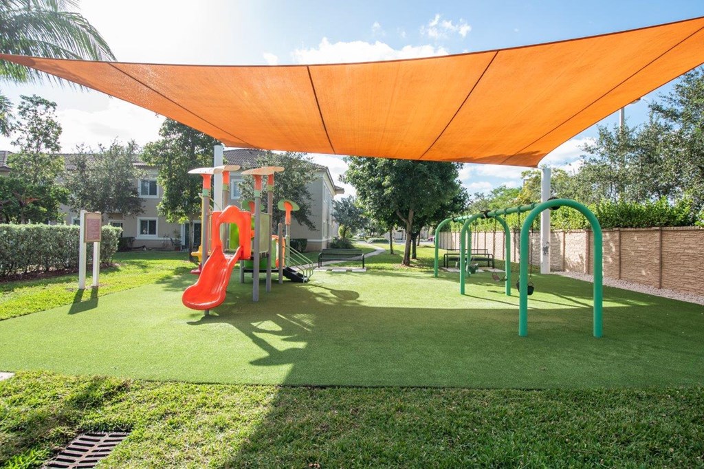 a playground with a shade canopy over it