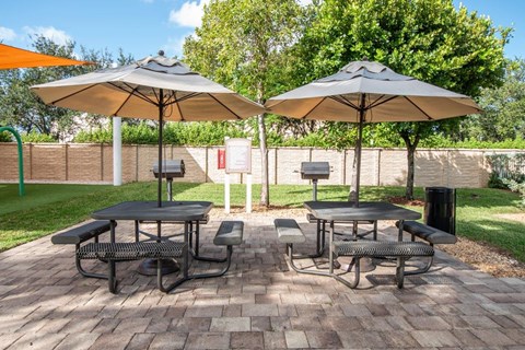 a patio with tables and umbrellas