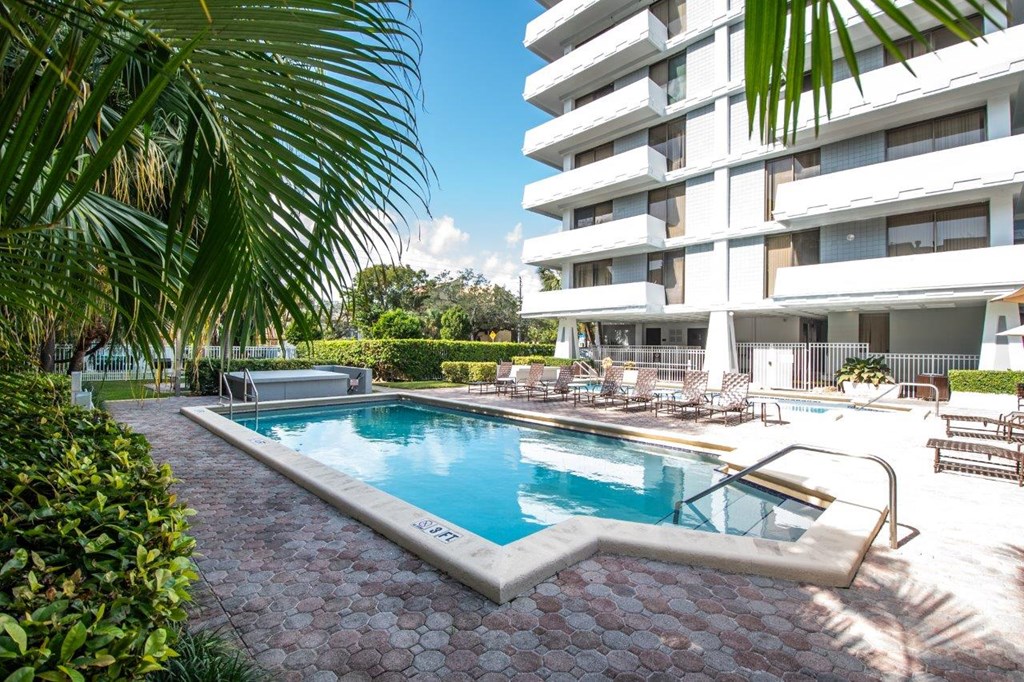 a resort style swimming pool in front of a building