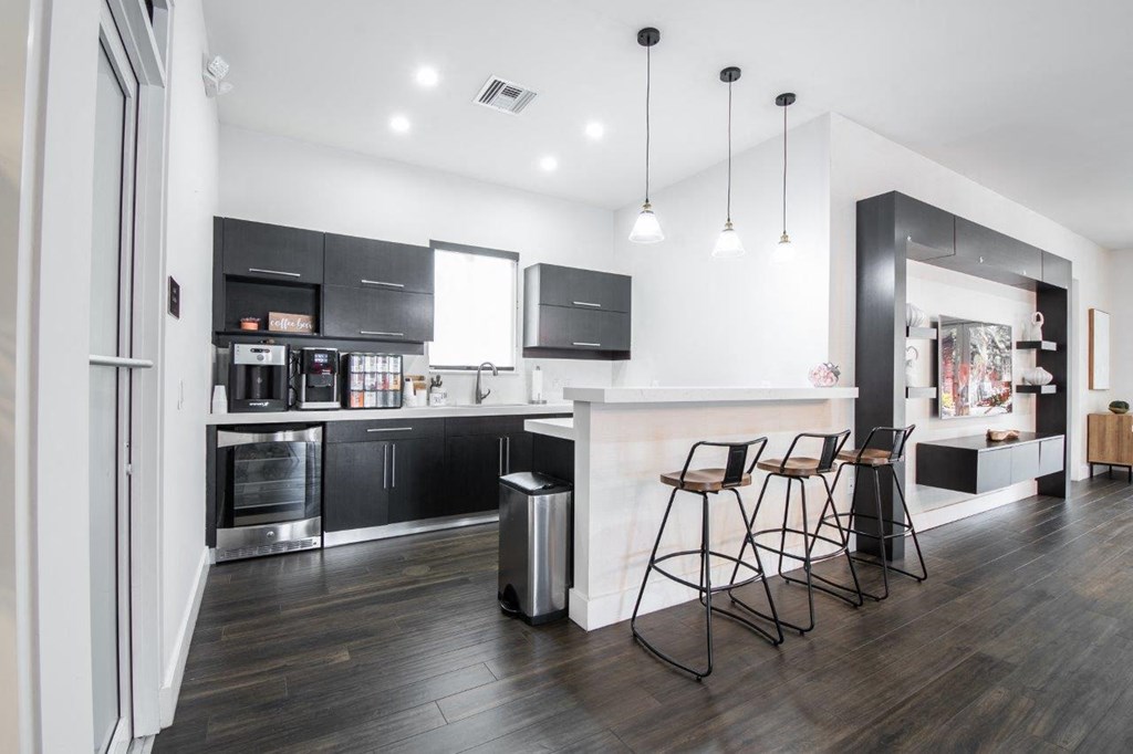 a kitchen and dining area with a counter and chairs