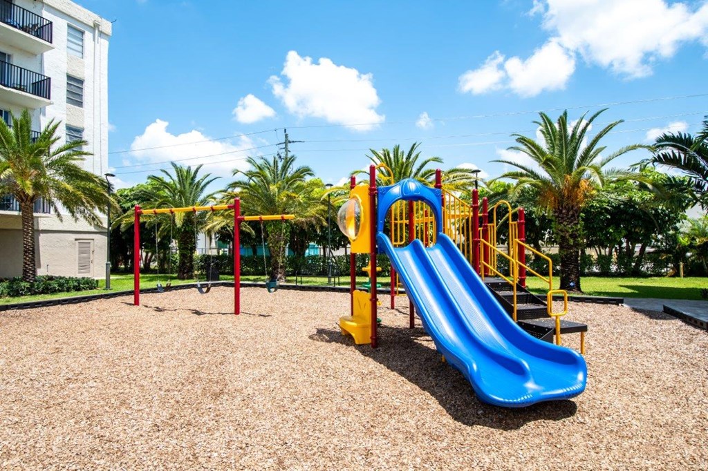 a playground with a blue slide at a park