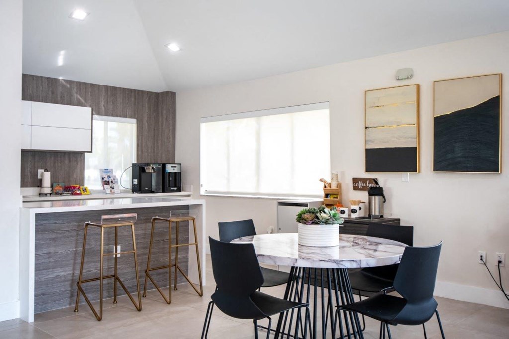 a kitchen and dining area with a table and chairs