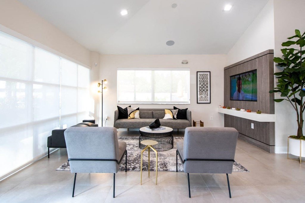 a living room with a couch and chairs and a table