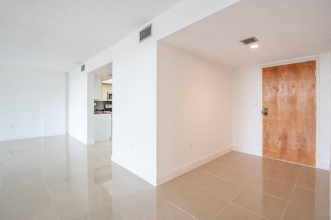 an empty living room with a wooden door