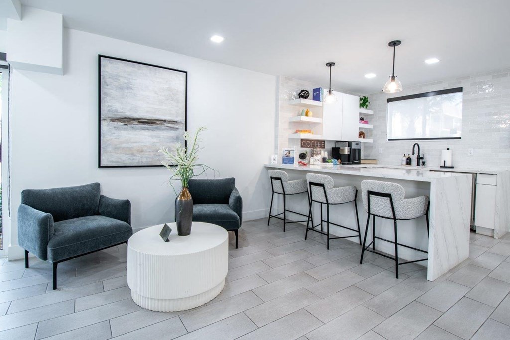 a living room with a kitchen and a table