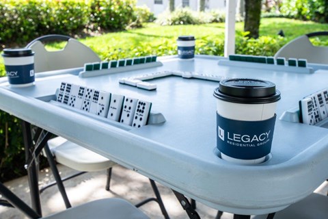 a table with a cup of coffee and game pieces on it