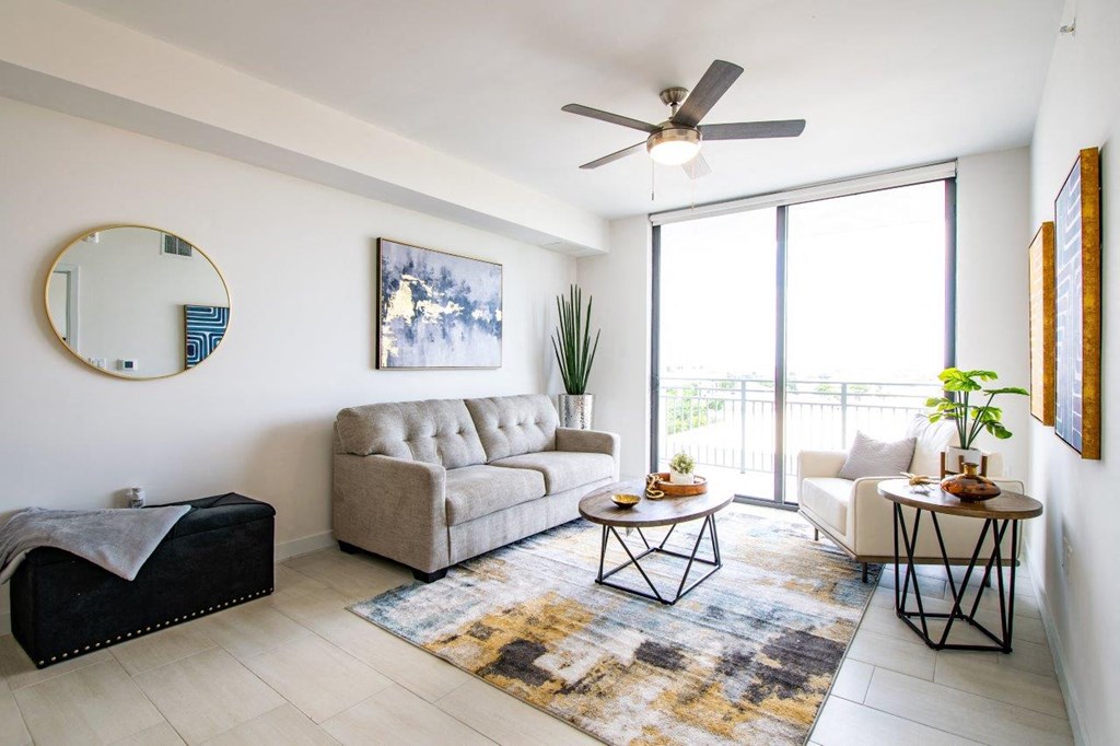 a living room with a couch and a ceiling fan