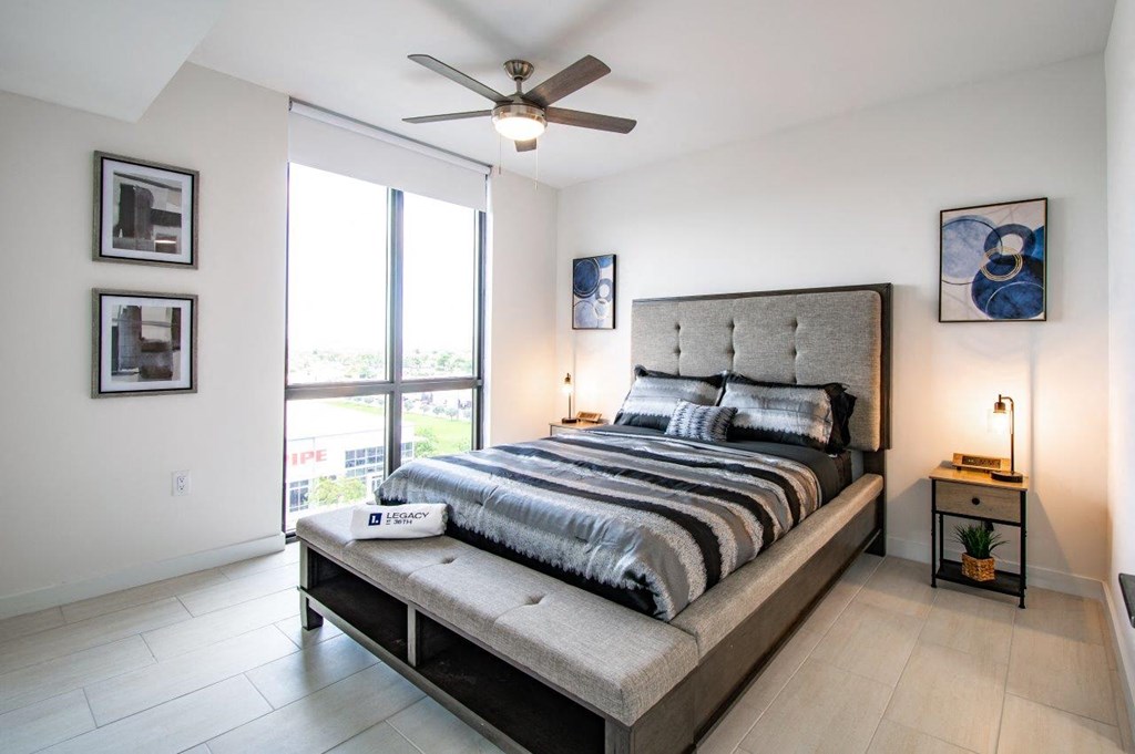 a bedroom with a bed and a ceiling fan