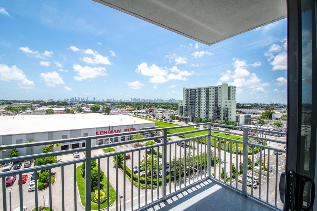 a view of the city from the balcony of a condominium